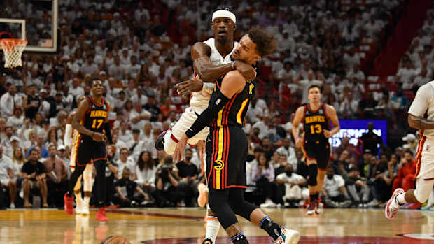 Jimmy Butler collides with Trae Young.